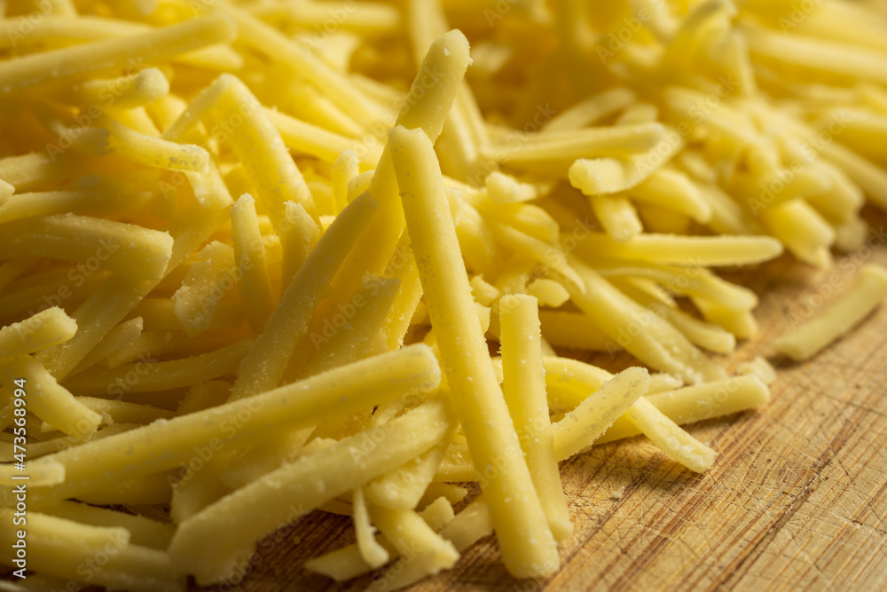 grated cheddar cheese background closeup