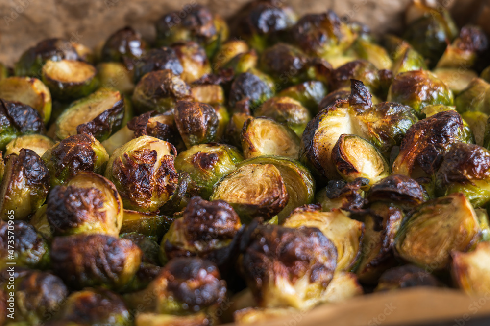 oven baked sliced brussels sprouts on baking tray closeup oven baked sliced brussels sprouts on baking tray closeup