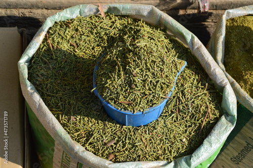 Close up of a sack full of jimbu herbs or  Nepalese Allium use in traditional medicine and cooking in Nepal photo