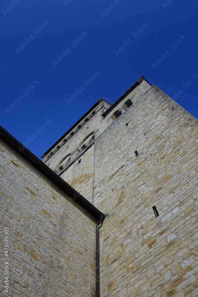 Hildesheim Cathedral, yellow sandstone clock tower under a blue sky on a sunny autumn day, Hildesheim, Lower Saxony, Germany