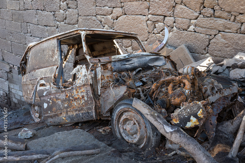 Abandoned and destroyed car in old village of Aceredo, Spain. It was left there abandoned during the submersion of the old village caused by the construction of the dam. photo