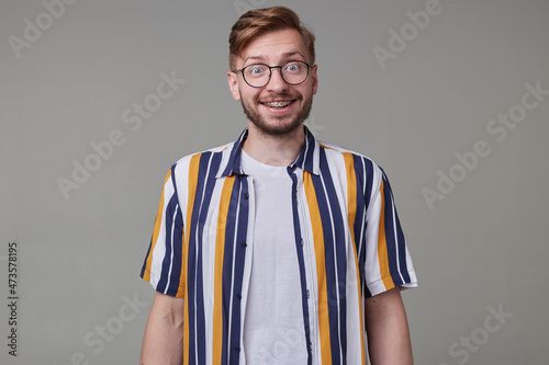 Wallpaper Mural Studio portrait of young bearded man, wears casually posing over gray studio background looks into camera with shocked facial expression. isolated. Torontodigital.ca