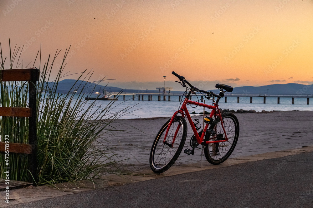Parked red bike near the beach