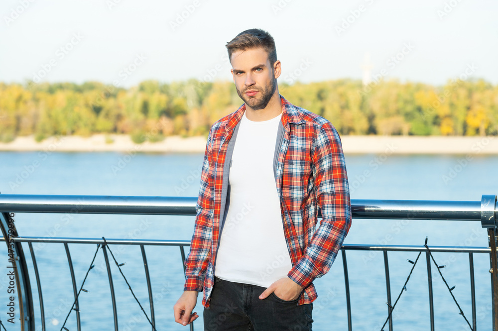 young trendy male fashion model in casual shirt outside, lifestyle