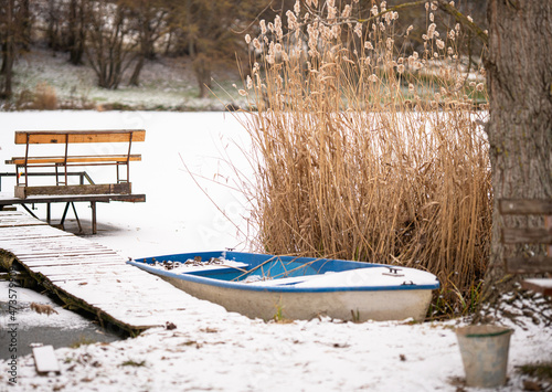 Pier at the frozen lake wit...