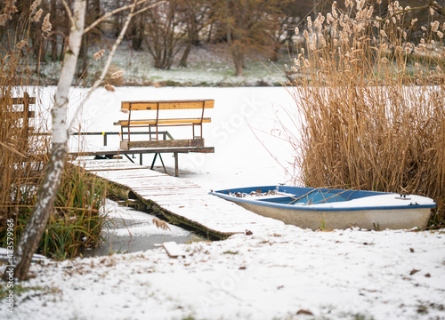 Pier at the frozen lake wit...