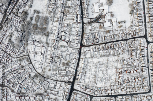 Straight down aerial photo in the winter time on a snowy day of the British town of Mirfield in Kirklees  West Yorkshire  England showing residential housing estates homes with snow covered roofs