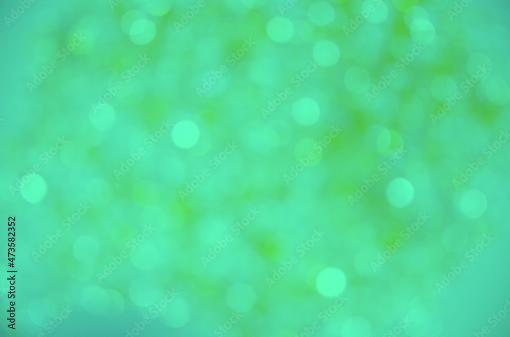 Festive background. Green background with bokeh. Blurred background. Abstraction circles.