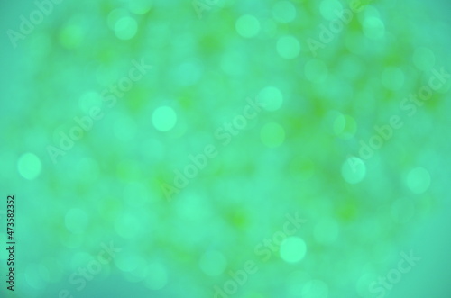 Festive background. Green background with bokeh. Blurred background. Abstraction circles. © Наталья Лукоянова