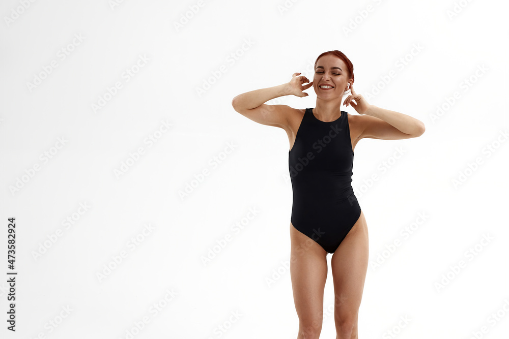 Fototapeta premium Joyful ballet dancer listening music in headphones