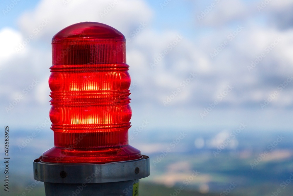 Red warning lights for air traffic on roof of high building, airport ...
