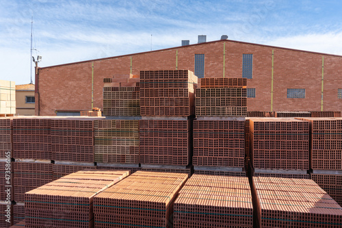 Stack of pallets with bricks, outside a brick factory.
