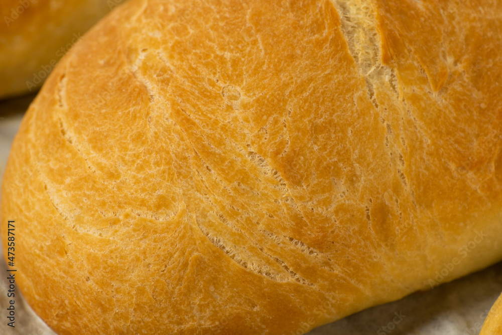 fresh baked loaves of bread on lie on a dark wooden table