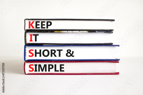 KISS keep it short and simple symbol. Concept words KISS keep it short and simple on books. Beautiful white table, white background. Business KISS keep it short and simple concept. Copy space.