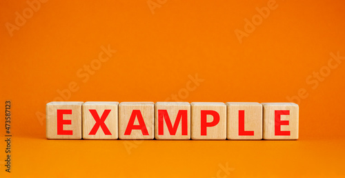 Example symbol. The concept word Example on wooden cubes. Beautiful orange table  orange background  copy space. Business and example concept.