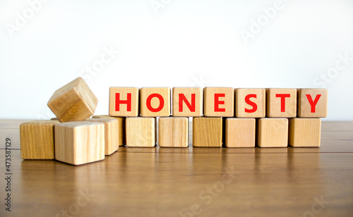 Honesty symbol. The concept word Honesty on wooden cubes. Beautiful wooden table, white background, copy space. Business and honesty concept. photo