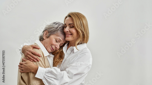 Fotografiet Loving adult daughter hug senior Caucasian mother