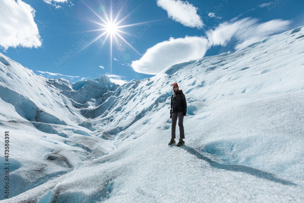 A woman posing on the ice formation of the Perito Moreno Glacier