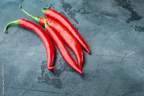Ripe red chili peppers, on gray background with copy space for text
