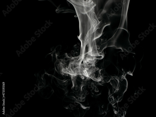 Chaotic mixing smoke creates abstract patterns on a black background