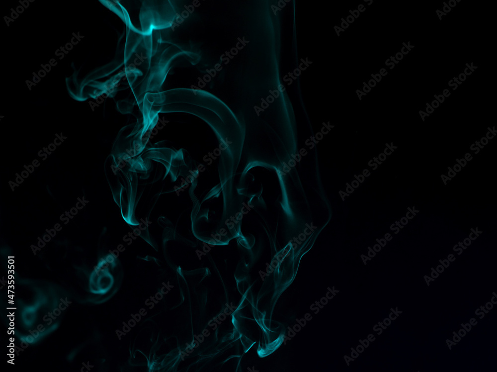 Fototapeta premium Chaotic mixing smoke creates abstract patterns on a black background