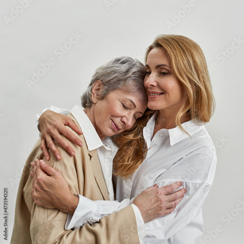 Caring adult daughter embrace senior mother