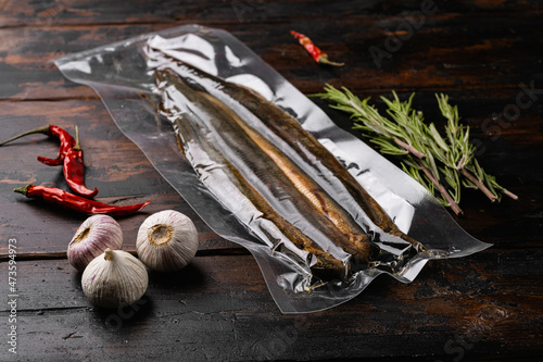 Grilled lamprey vacuum pack, on old dark  wooden table background