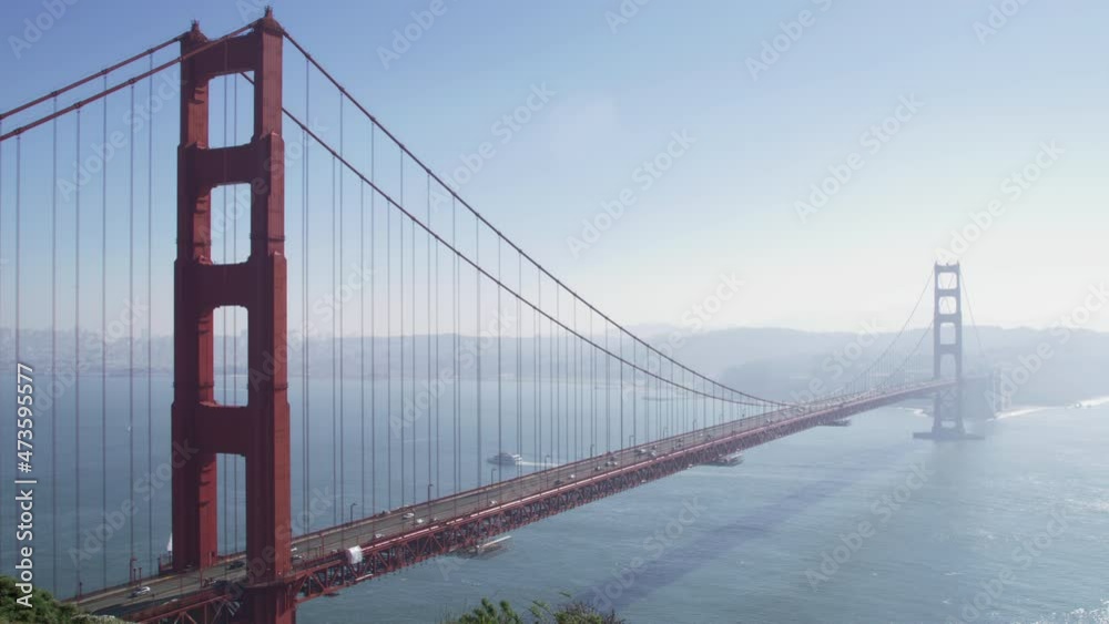 Scenic still view of Golden Gate Bridge, RED camera shot with copy space on blue sky background. World famous red suspension bridge landmark. City traffic on sunny summer day, West Coast USA tourism Scenic still view of Golden Gate Bridge, RED camera shot with copy space on blue sky background. World famous red suspension bridge landmark. City traffic on sunny summer day, West Coast USA tourism