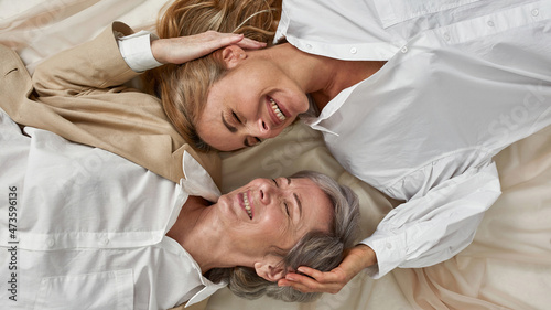 Photographie Wide of smiling old mom and adult daughter laugh together