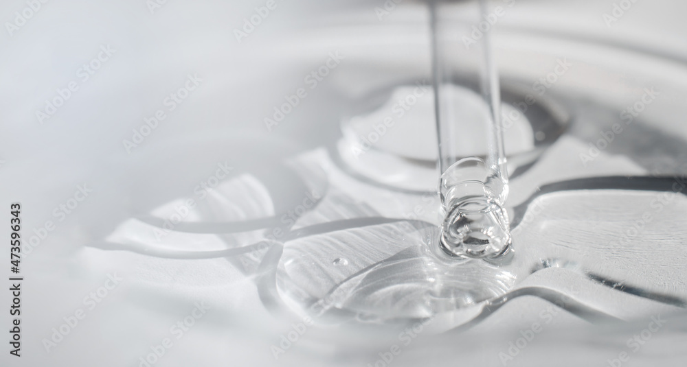 Transparent cosmetic gel in a Petri dish with a pipette. Close-up - the structure of the gel.
