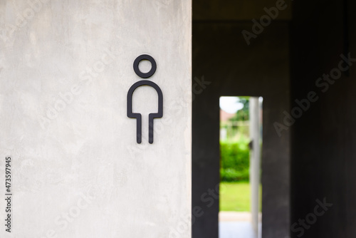 Men toilet sign on concrete wall outside the public toilet