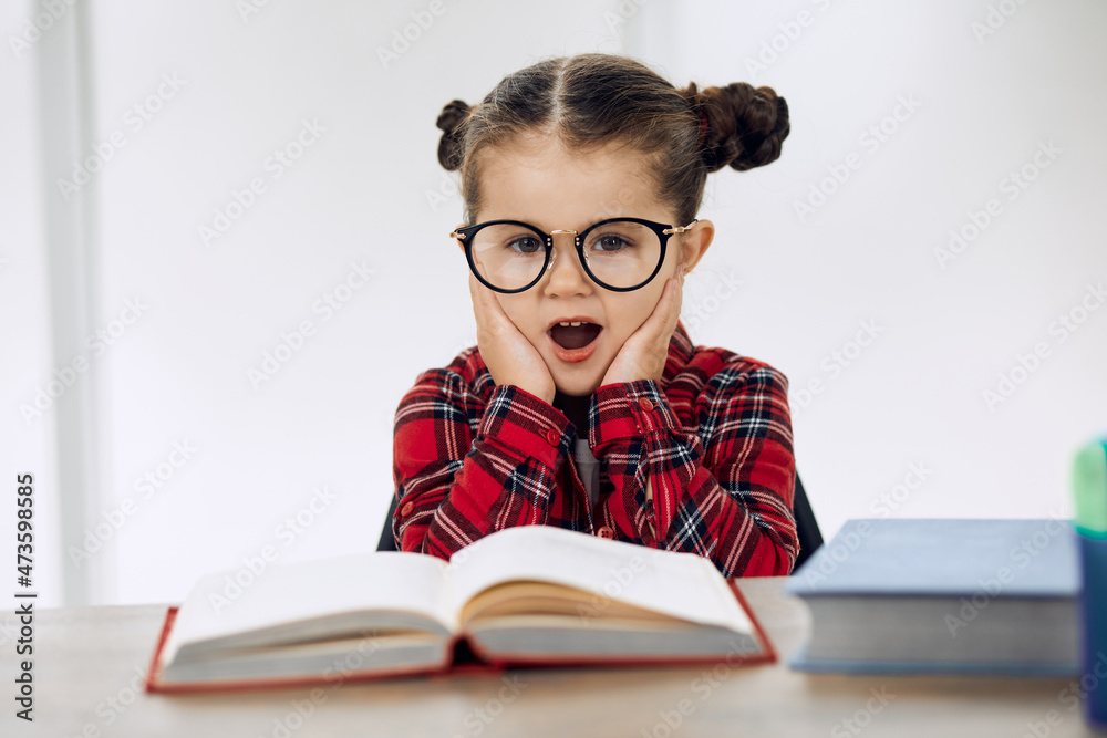 Little girl wearing glasses and doing homework. Upset. Little girl wearing glasses and doing homework. Upset.