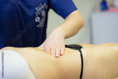 girl doing belly massage with oil