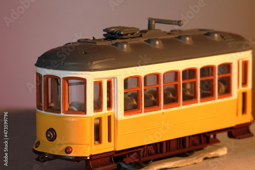Old yellow Lisbon toy tram, isolated