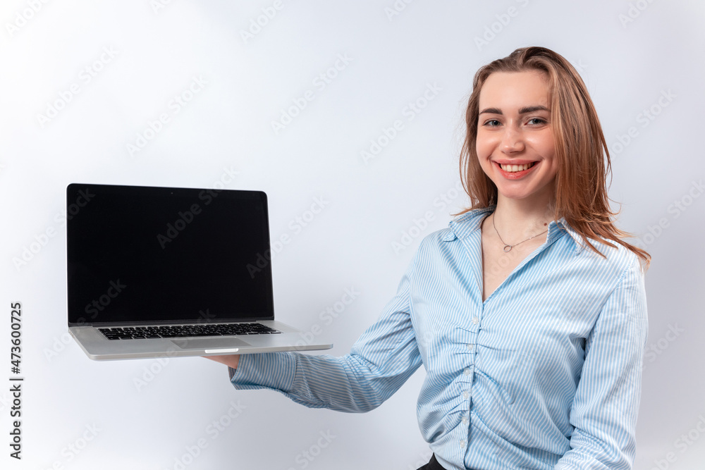 smiling businesswoman in a blue blouse showing laptop screen. isolated