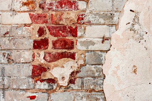 Texture of a brick wall with cracks and scratches which can be used as a background