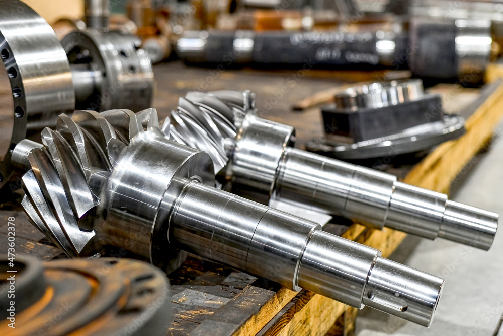 The two toothed gears, after reworking in the machine, lie on the beams in the workshop. The two toothed gears, after reworking in the machine, lie on the beams in the workshop.