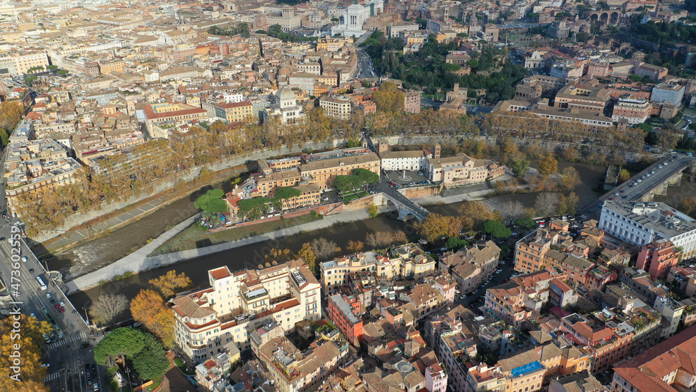 Aerial drone photo of Tiber island or Isola Tiberina, a small island in a bend of the River Tiber with a number of historical buildings and monuments, Rome historic centre, Italy