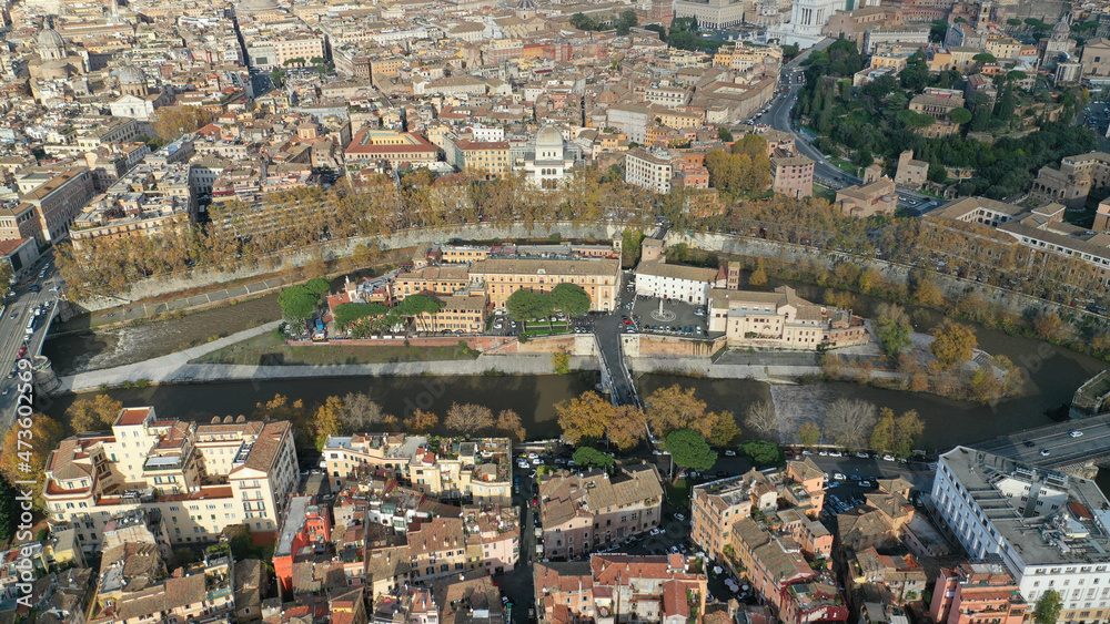 Aerial drone photo of Tiber island or Isola Tiberina, a small island in a bend of the River Tiber with a number of historical buildings and monuments, Rome historic centre, Italy