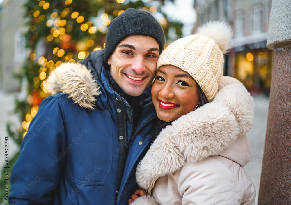 Portrait of a beautiful young couple on a christmas background with bokeh lights