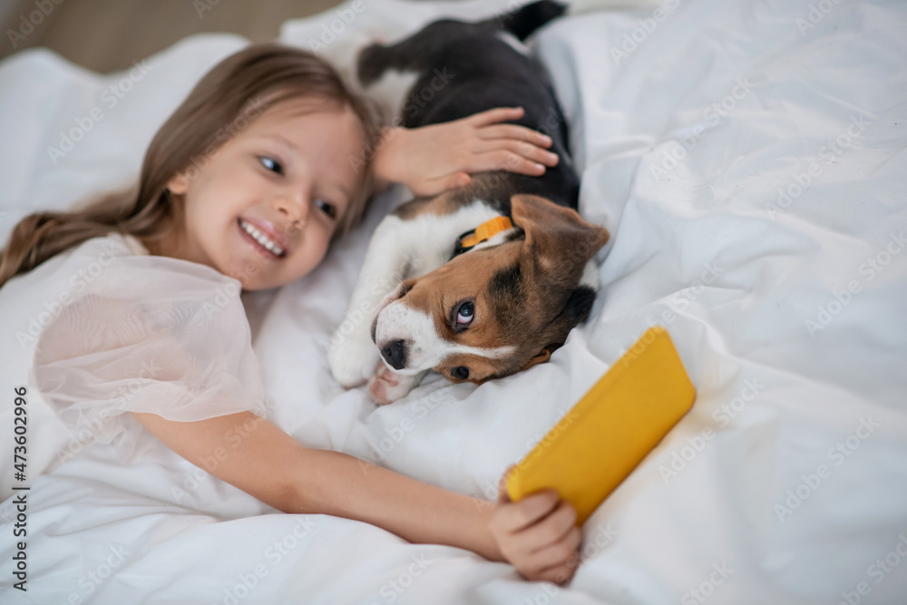 Pretty little girl taking selfies with her funny four-legged friend Pretty little girl taking selfies with her funny four-legged friend