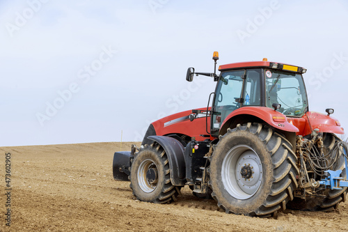 Large tractor on the field. Sowing of grain  vegetable crops.