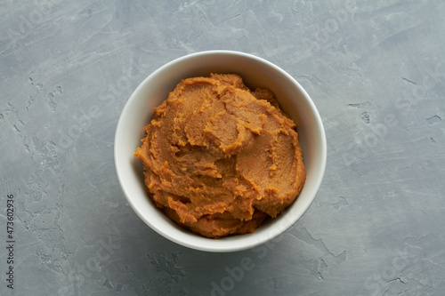 miso paste shiro miso in a bowl on grey background photo