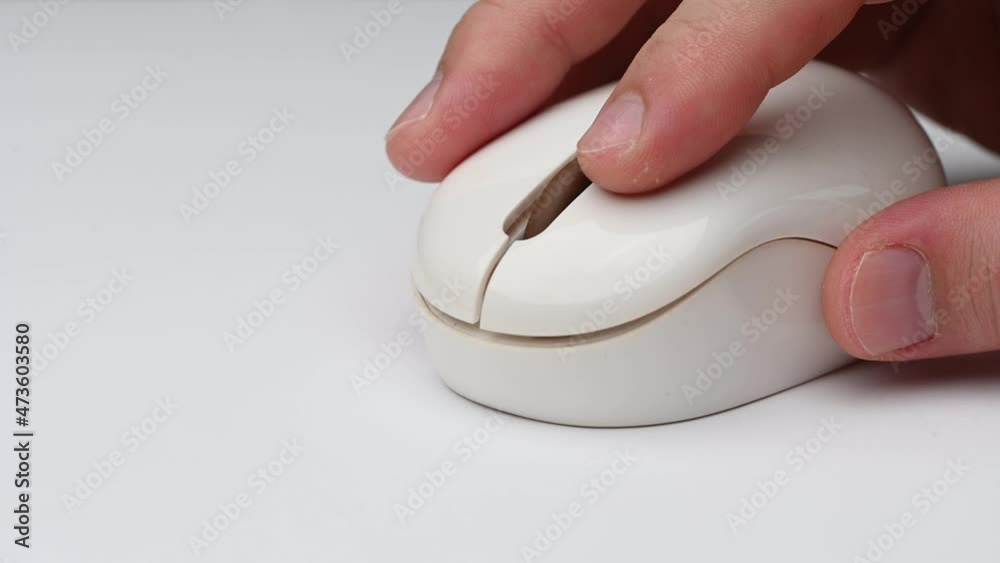 Clicking digital wireless mouse and working on computer at the office. Close up hand on mouse. The concept of using technology. Computer for business. Clicking digital wireless mouse and working on computer at the office. Close up hand on mouse. The concept of using technology. Computer for business.