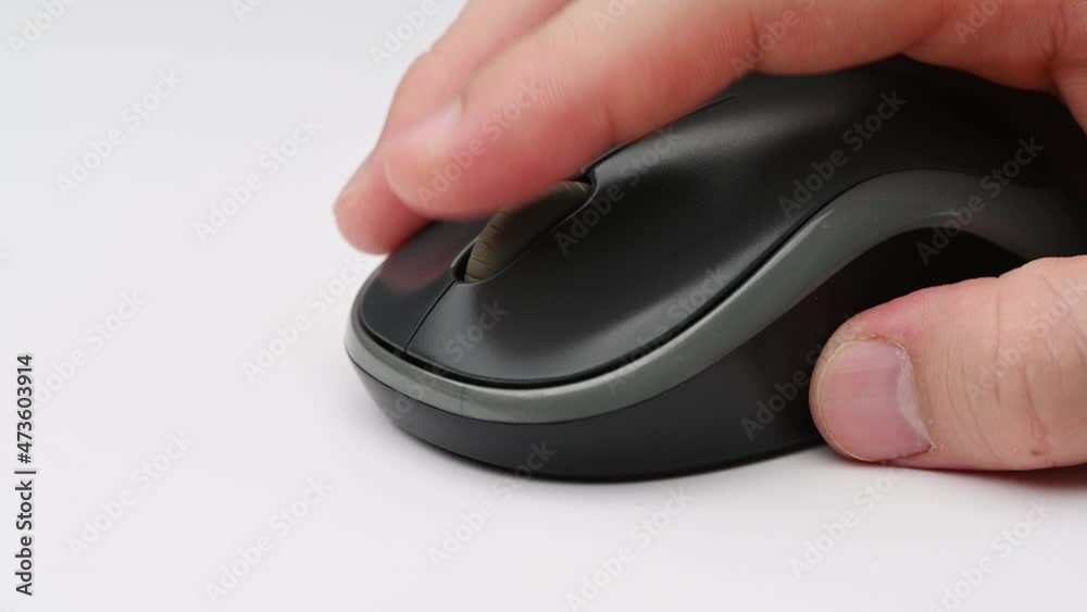 Clicking digital wireless mouse and working on computer at the office. Close up hand on mouse. The concept of using technology. Computer for business. Clicking digital wireless mouse and working on computer at the office. Close up hand on mouse. The concept of using technology. Computer for business.