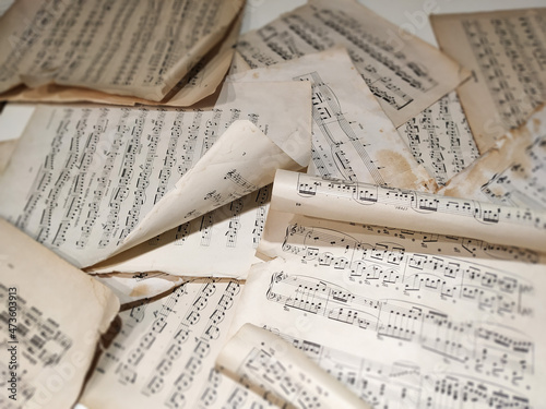 Music sheets with sheet music - the score, lie in disarray on the piano lid.  