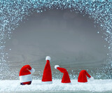 Four red Santa Claus hats on white snow .