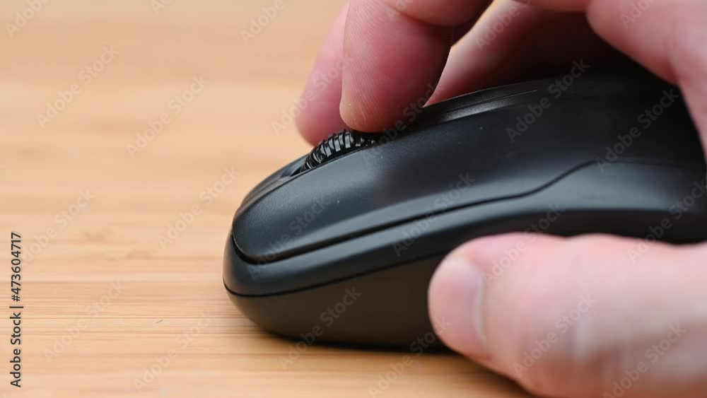 Clicking digital wireless mouse and working on computer at the office. Close up hand on mouse. The concept of using technology. Computer for business. Clicking digital wireless mouse and working on computer at the office. Close up hand on mouse. The concept of using technology. Computer for business.