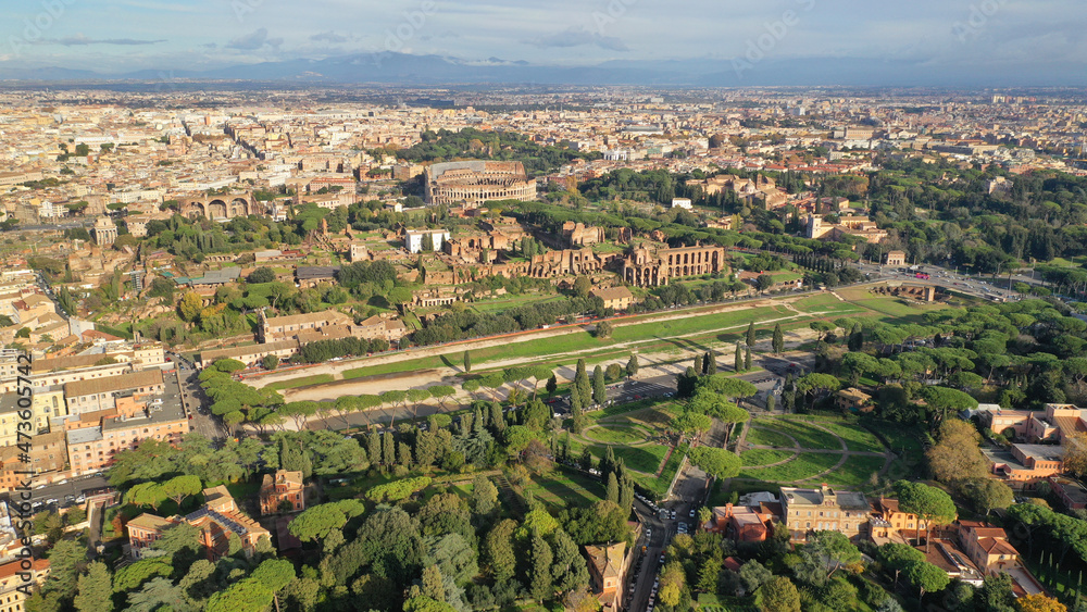 Aerial drone photo of iconic Circus Maximus a green space and remains of a stone - marble arena used for chariot races built next to Palatine hill and world famous Colosseum, historic Rome, Italy