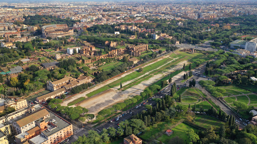 Aerial drone photo of iconic Circus Maximus a green space and remains of a stone - marble arena used for chariot races built next to Palatine hill and world famous Colosseum, historic Rome, Italy photo